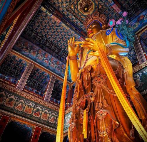 (via Statue of Maitreya Buddha inside the beautiful interior of Lama Temple, Beijing, China (1694 AD