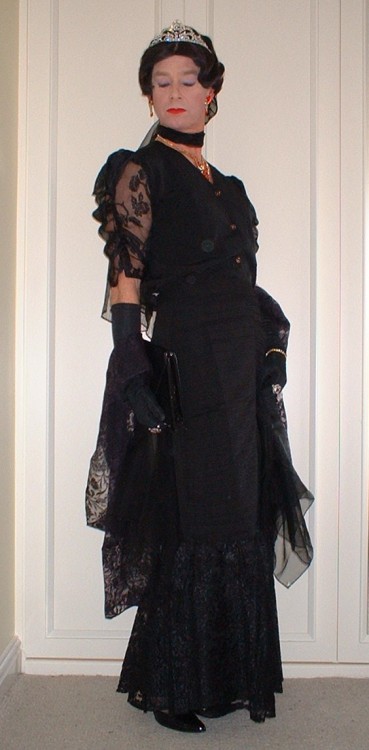 Long flounced evening skirt with chiffon sleeved blouse, chiffon scarves and wrap, patent black clut