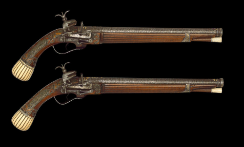 A set of Turkish miquelet pistols, gold inlaid Damascus barrels, engraved silver mounts, and an ivor