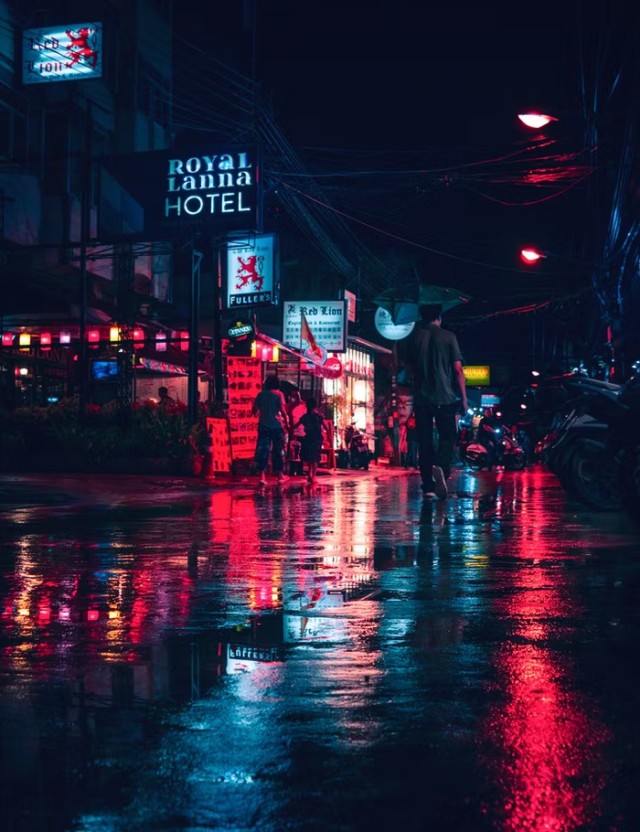 people walking on a busy street during night time 