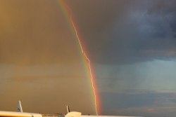 blazepress:  Lightning strikes a plane as it flies through a rainbow.