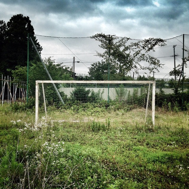 An overgrown football goal on an abandoned school field inside the #Fukushima nuclear Exclusion Zone. Over 80,000 people including many children are perminantly displaced from their homes due to the 2011 triple disaster in #Japan