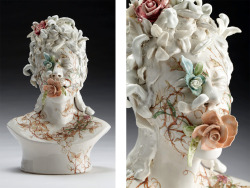 who-:  Haunting ceramic faces overgrown with