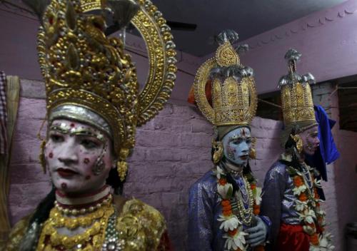  Artists stand as they wait to take part in a religious procession ahead of the Hindu festival of Du