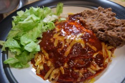 xuevez:  My girlfriend made her (and now our) favorite dish, New Mexico enchiladas. There’s a runny fried egg hiding there under the red chili.    That looks good.