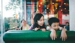 khoaphamphotography:  Kids | Tụi con nít  I went out with my friend and met these 2 kids at Lotteria yesterday. The girl is afraid of taking pictures because she think she could be sold to China. And the boy asked my female friend “Are you two