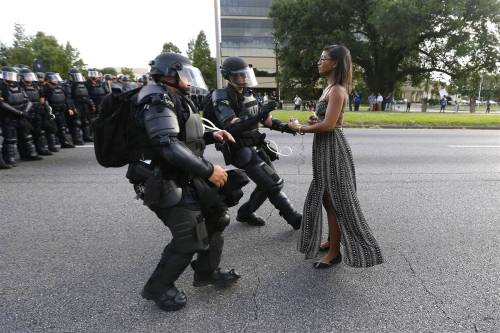 It’s the image that is defining a protest movement. A woman in a summer dress is photographed 