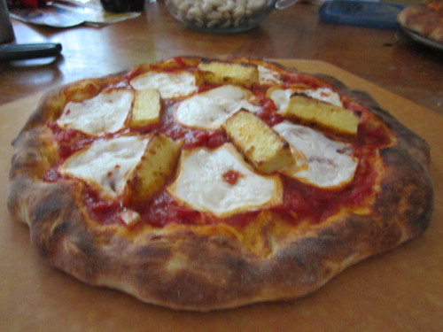 veganpizzafuckyeah:  reblogged from notrealfood:  Two pizzas topped with fried tofu (battered with flour, nutritional yeast, sea salt, ginger, wasabi, and ground chipotle pepper), Teese mozzarella, and a little bit of chili oil. Same NY-style crust as