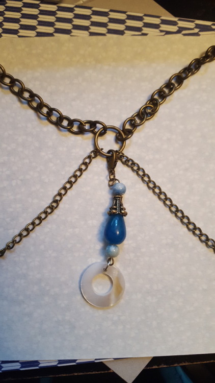 A small charm on a choker I made. The charm itself is dedicated to Tefnut, with a blue agate teardro