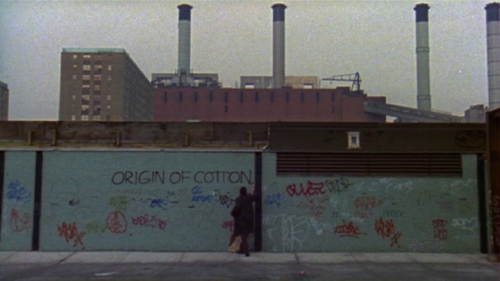 Jean-Michel Basquiat writing “ORIGIN OF COTTON” on a wall.(still from Boom for Real: The Late Teenag