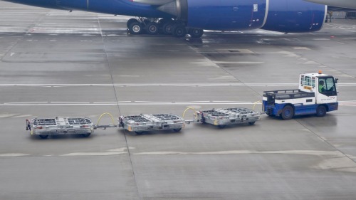 Make way for trucklings A little tractor pulls along its brood underneath the looming engines of a B