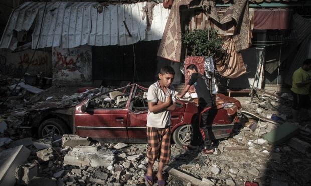  Airstrikes in Gaza | July 2014 1. An Israeli activist carries a placard during