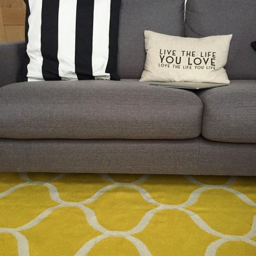 Grey sofa - black &amp; white stripped cushions - bright yellow rug. All coming together. Now ju