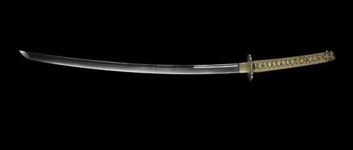 Tachi or court sword, with curved pointed tempered single-edged steel blade, a ray skin hilt bound w