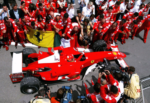 CANADA, 2004 — Michael Schumacher, 1st position, celebrates with his team as he pulls into the pits.