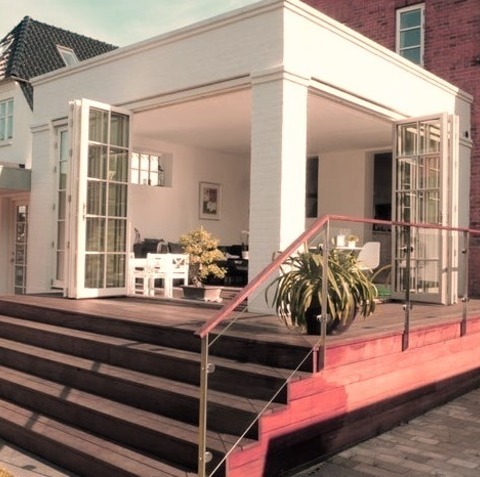 Transitional Deck OdenseMid-sized Transitional Backyard Deck Design With An Addition Of A Roof.