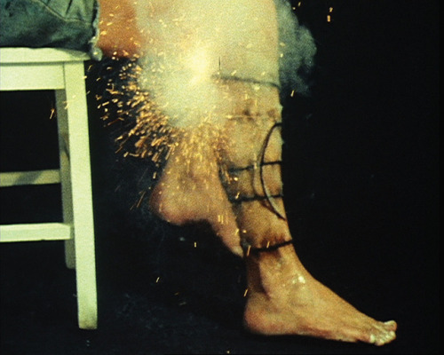 gucciballs:Rules & Displacement Activities Part II, Leg Spiral (Mike Parr, 1975)Infected Leg Spi
