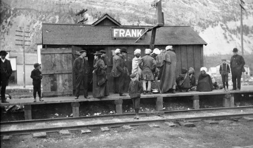 Group, including East Indians, on platform of C.P.R. (Canadian Pacific Railway) Station, Frank, Alta