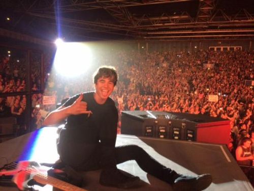 Some Pictures Of Calum Sitting Onstage For The Vibes