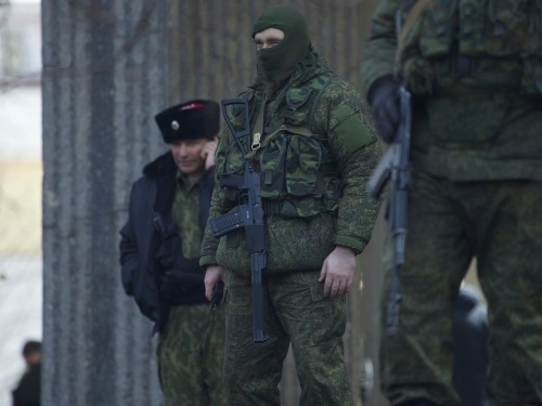 gunrunnerhell:  The Russians Heavily-armed soldiers without identifying insignia guard the Crimean parliament building after taking up positions there earlier in the day on March 1, 2014 in Simferopol, Ukraine. The soldiers’ arrival comes the day after