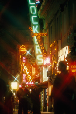 natgeofound:  Neon signs blur the night scene as marines walk on the street in San Diego, California, July 1969.Photograph by James L. Amos, National Geographic