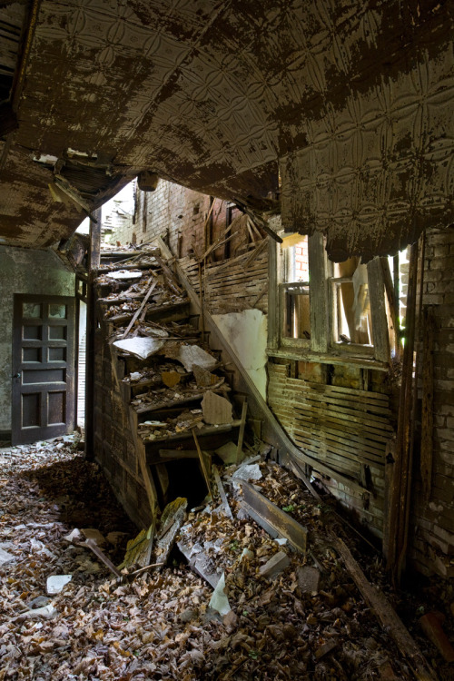 Collapsing main staircase inside the Doctors’ Cottage on North Brother Island.  The central section of this building - which this staircase used to connect - is mostly collapsed; it would be extremely unwise to venture into this part of the building.