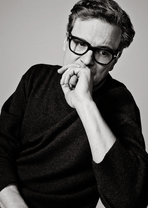 Older Colin Firth wearing a dark turtleneck and glasses