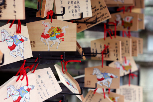 people’s hopes and prayers written down on ema (絵馬) at a shrine for the gods to receive