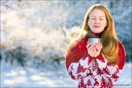 Beautiful girl drinking hot tea in cold winter forest (by Dmitry Mordolff)