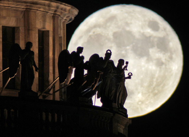 Sculptures at St. Isaak’s Cathedral in St. Petersburg, Russia, are silhouetted by the rising full moon. Photo by Dmitry Lovetsky