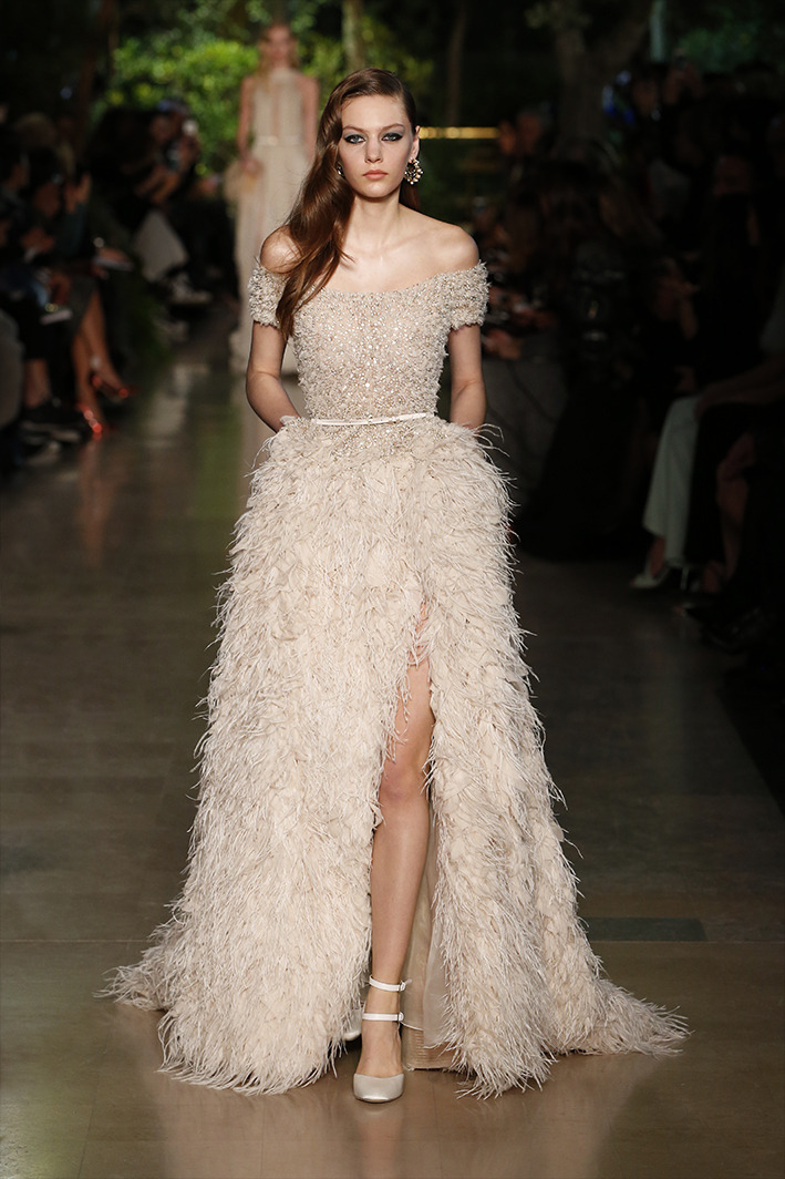 eliesaab:Ivory couture gowns dressed with lace and feathers, sequins and pearls.