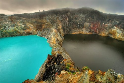 dichotomized:  The Lakes of Mount Kelimutu, Indonesia are considered to be the resting place for departed souls, the lakes are locally referred to as “the lake of evil spirits”. All 3 lakes change colour from blue to green to black or red unpredictably.