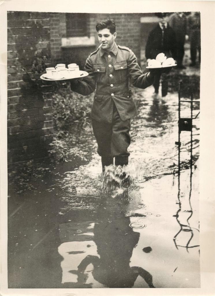  1939 - British soldier takes tea to comrades working to repair banks of River Ravensbourne