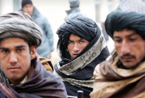 Former Taliban militants attend a ceremony with the Afghan government after handing over their weapo