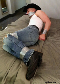 ducttapedup:  atlleather:  The Cowboy in trouble once again!  Dad taped his son up to teach him a lesson for his back talk and disrespect. Soon after, his daddy would duct tape his hands to the mower to mow the few acres they owned. Good punishment. 