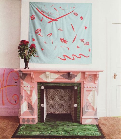 80sdeco: red and pastel blue textile, pink and grey patterned fireplace, original green glazed tile