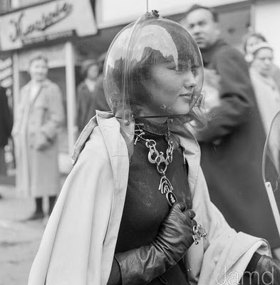 atomic-flash:  Vintage photo of a grown-up space girl wearing the Arant Plastics egg-helmet. Notice the stares of the crowds behind her, wishing they too owned their very own Egg.