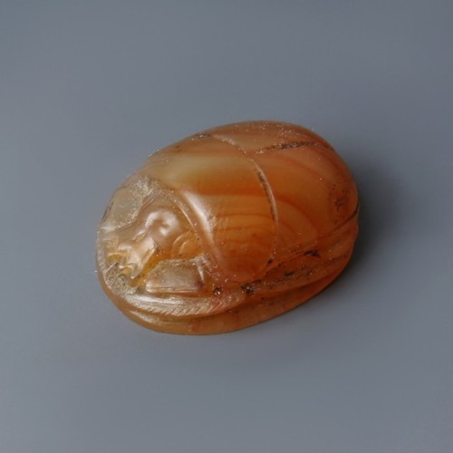 Carnelian Scarab AmuletA beautiful Egyptian scarab amulet made in bright carnelian. The front depict