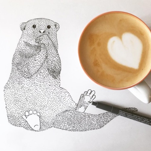 drinking coffee and drawing an otter