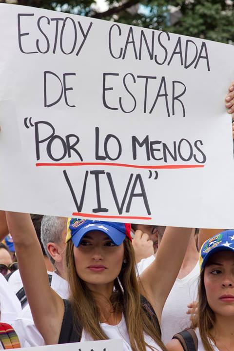 suaracatacat:  This was Genesis Carmona, the model that, after struggling for her life since yesterday, died today February 19th. She was shot in the head by the governments armed symphatizers. Her sign reads: -I am tired of being “at least alive”-.