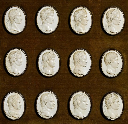 hadrian6:A FRAMED COMPOSITION OF TWELVE FINELY CARVED IVORY MEDALLIONS OF ROMAN EMPERORS AND A CARVE