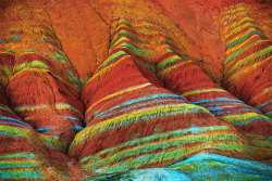 sixpenceee:  Danxia Landforms, ChinaThese colorful rock formations are the result of red sandstone and mineral deposits laid down over millions of years. Wind and rain then carved amazing shapes into the rock, forming natural pillars, towers, ravines,