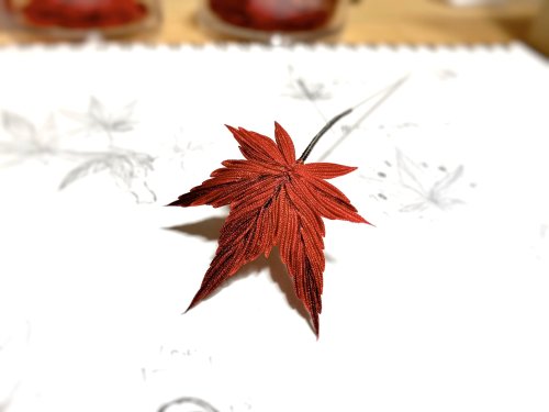 Delicate momiji (red maple leaves) hairpins, made using modern tsumami zaiku technique