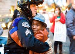 gvnkin:  thechanelmuse:   Photographer Says ‘Ferguson Hug’ Photo With Young Black Child And White Officer Was Staged In the picture, a teary-eyed 12-year-old Devonte Hart is hugging officer Brett Barnum during a demonstration in Portland, OR. Hart