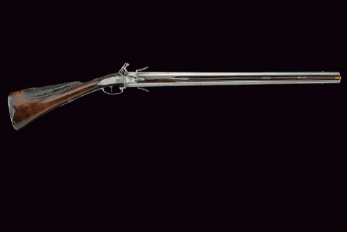 A double barrel over and under swivel barrel flintlock shotgun  signed “Cousin au Chateau de R