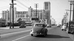 losangelespast:  Boyle Heights, 1950. Olympic Boulevard near Soto Street, with the Sears Building in the background.