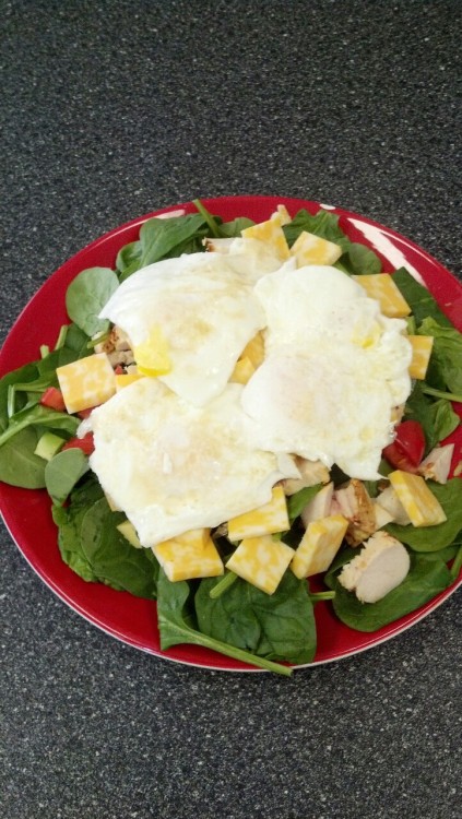 fitchris25:  Spinach salad with avocado, tomato, chicken breast and cheese. And, of course, topped with four fried eggs.k