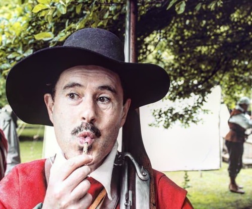 Musketeer Kel keeps his match burning during an event at Peterborough Cathedral by gently blowing on