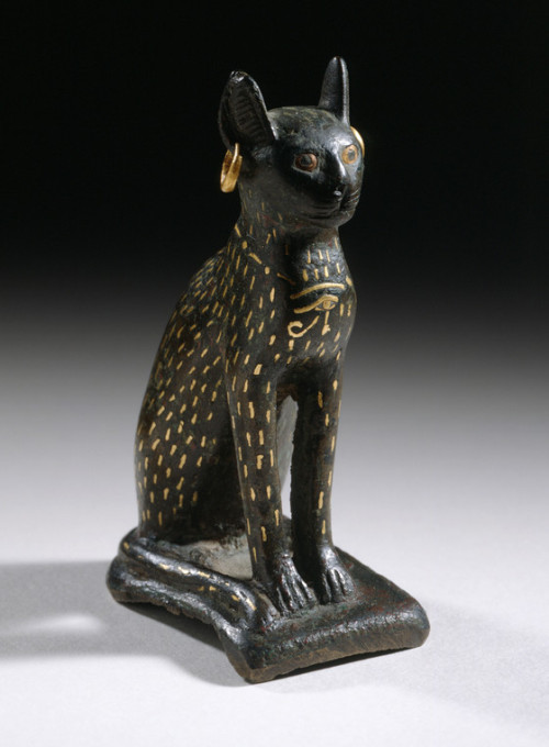 egypt-museum: Figurine of the Goddess Bastet as a Cat Bronze, inlaid gold. Third Intermediate Period