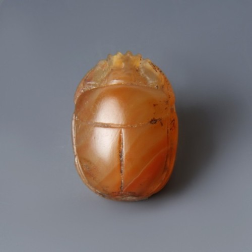 Carnelian Scarab AmuletA beautiful Egyptian scarab amulet made in bright carnelian. The front depict